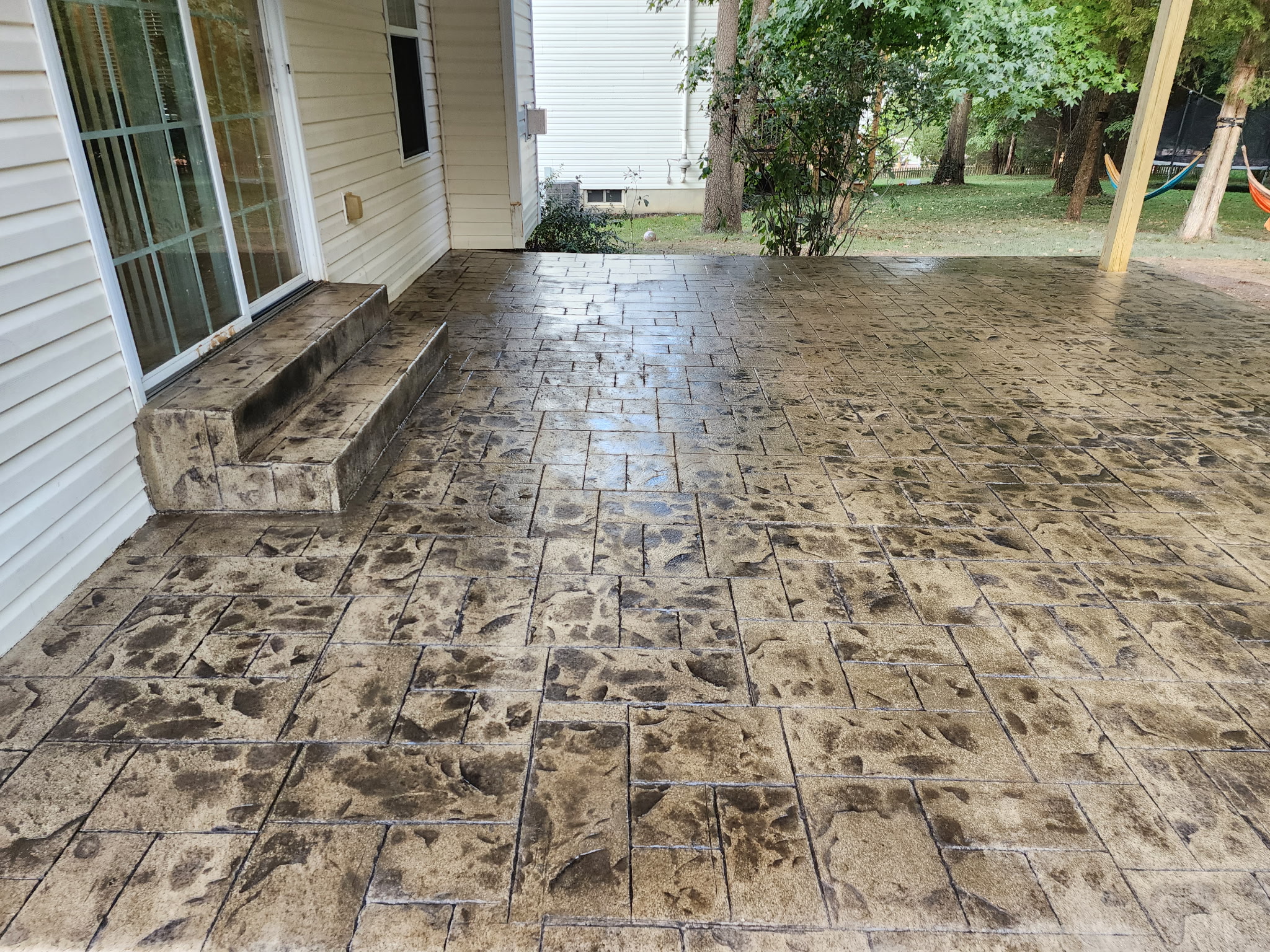 Stamped stone-pattern concrete patio