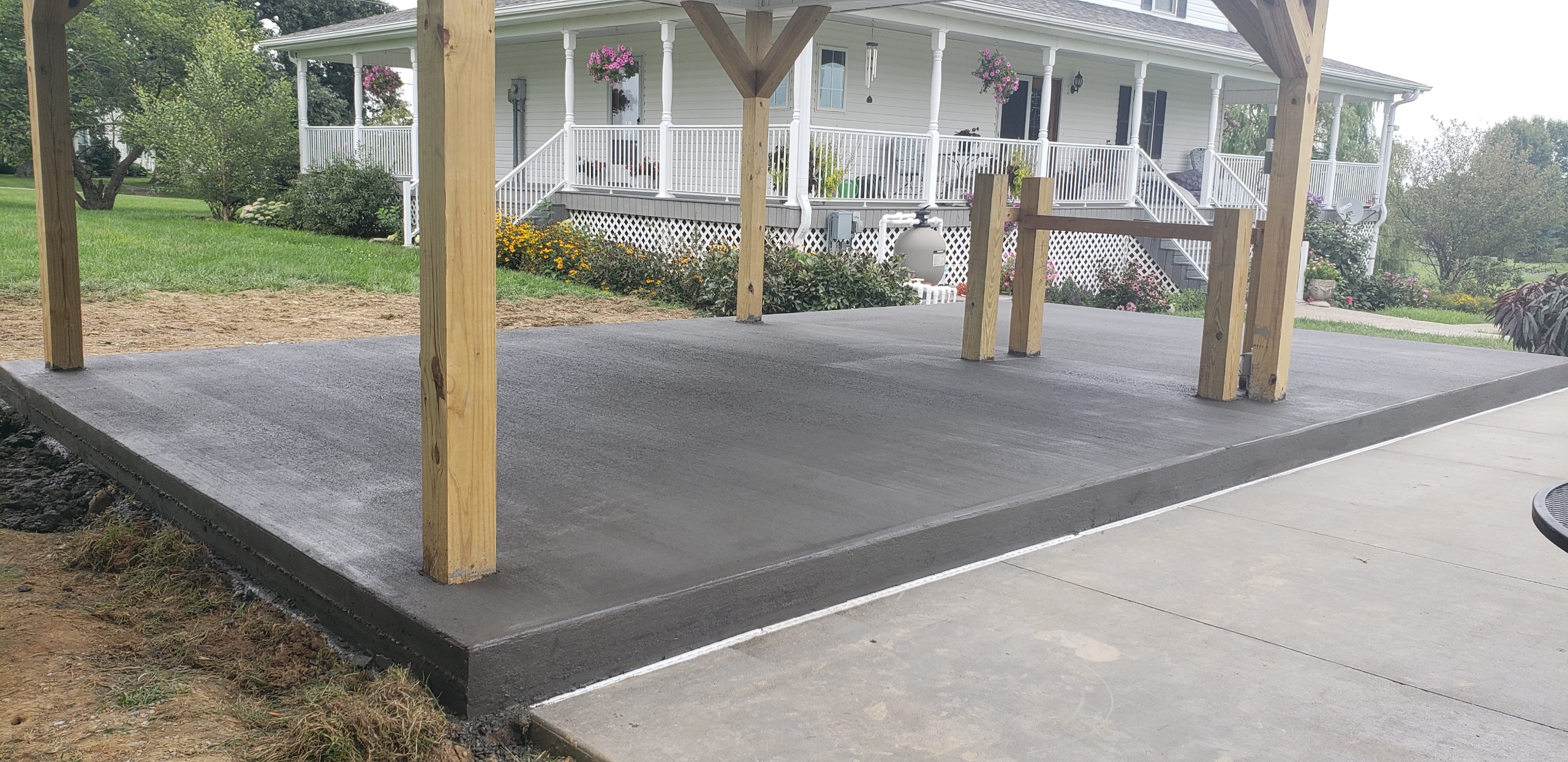Concrete slab under pergola at residential home