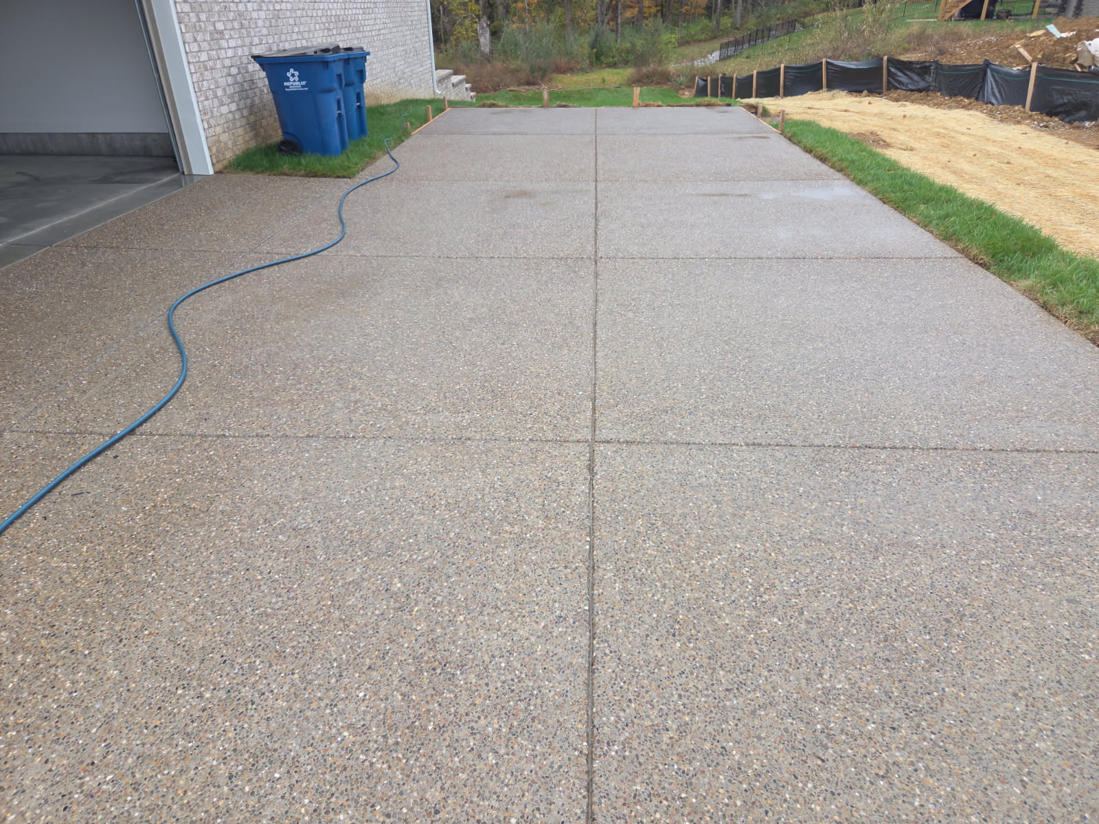 Exposed aggregate concrete driveway by Coaty and the Crew